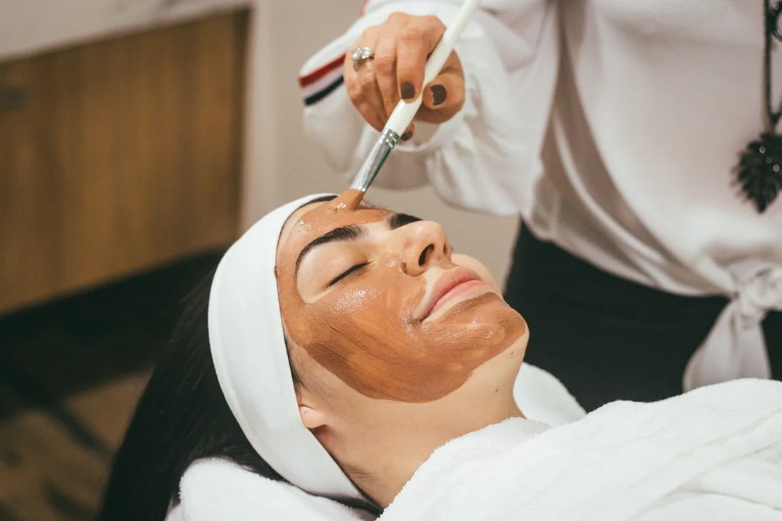 Hands applying skincare
